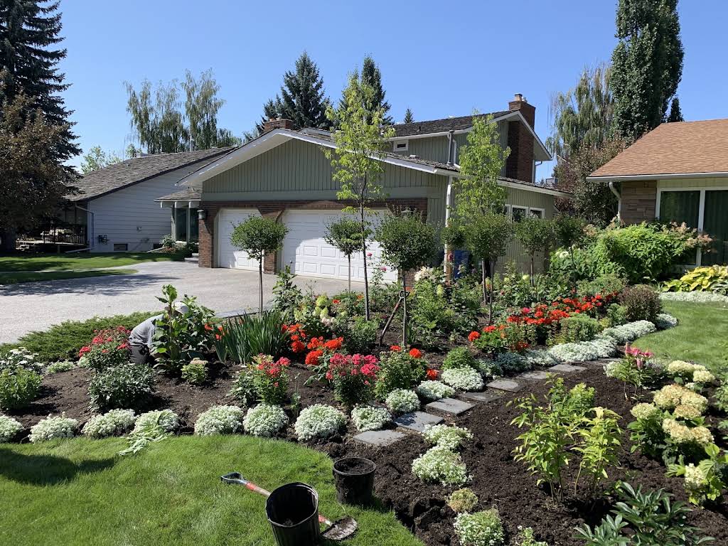Black Mountain Landscape crew tending a colourful residential flower bed